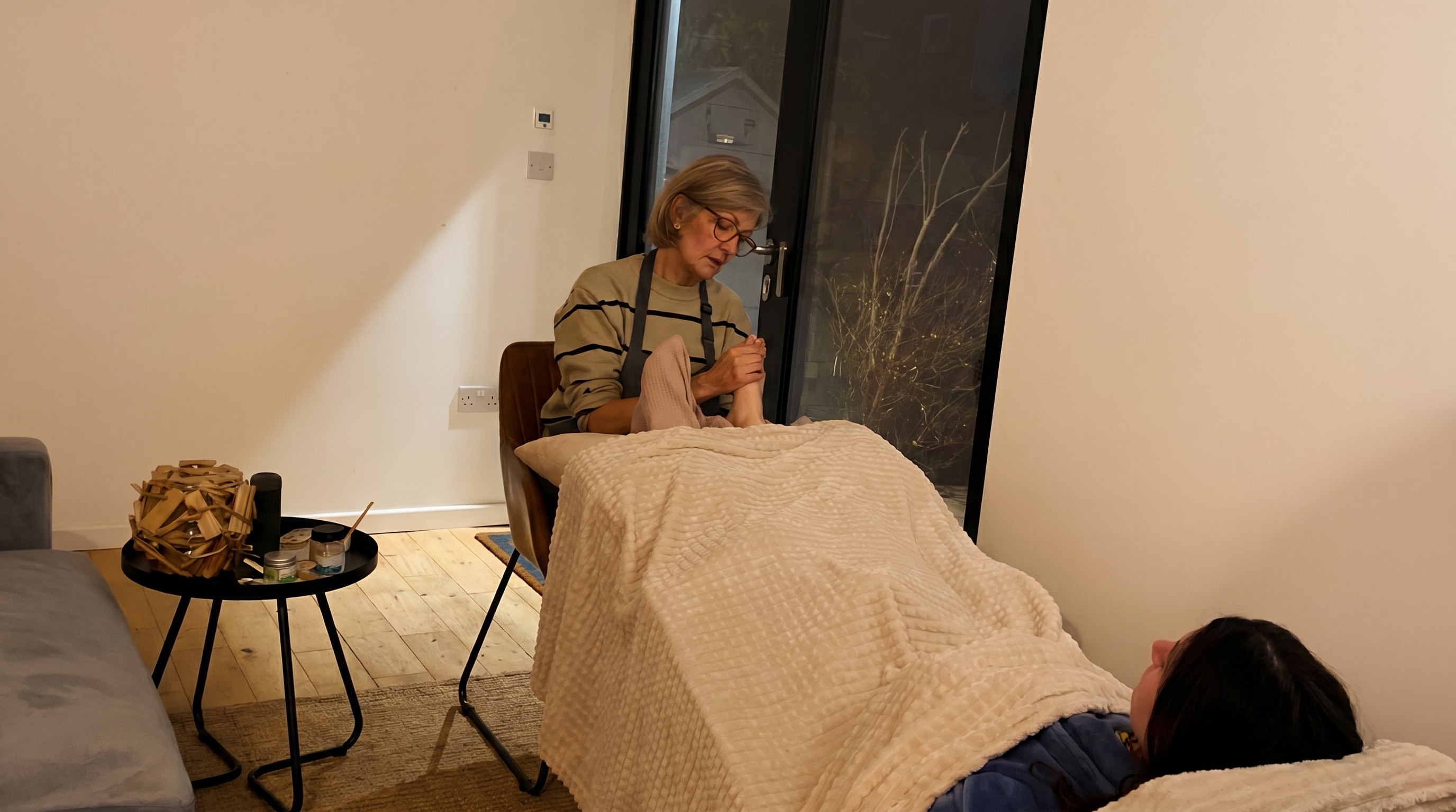 Anna performing foot reflexology treatment in Wimbledon